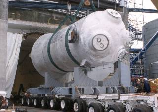Lower section of the steam generator being hauled out of the generator building