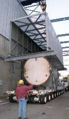 A cover being placed on the lower portion of the steam generator on a flatbed semi trailer